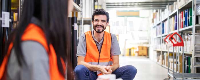 Warehouse workers laughing together