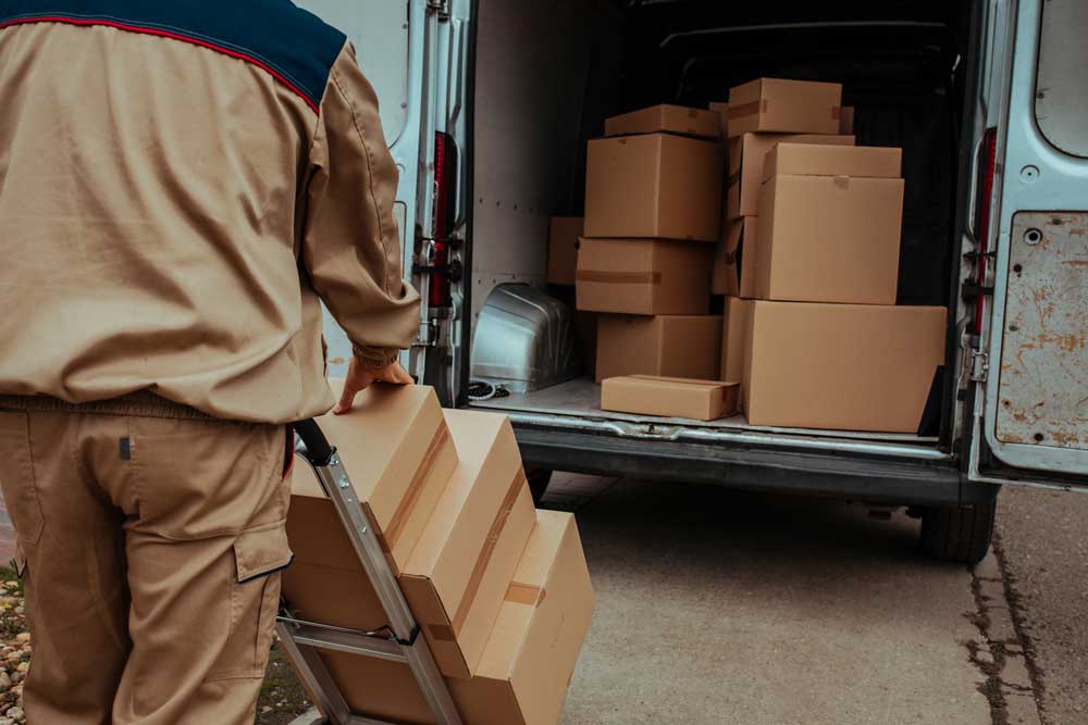 Courier transporting packages in a car